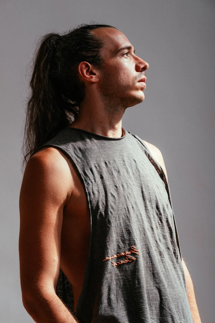 Zeyan Castracane. Side profile with long hair tied back. Colour portrait.